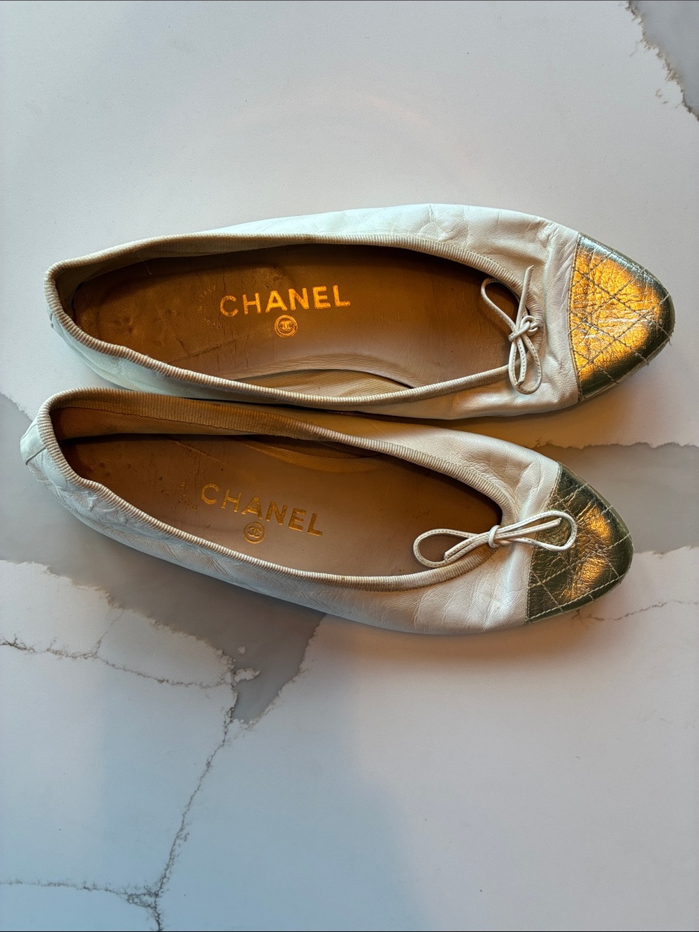 CHANEL White Leather Ballet Flats with Gold Cap Toe